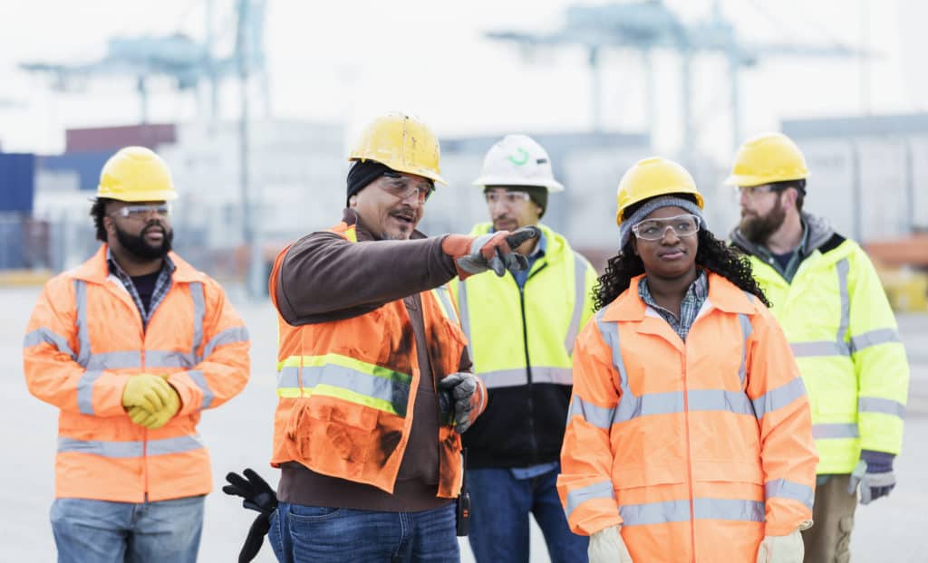 Photo of five young construction workers