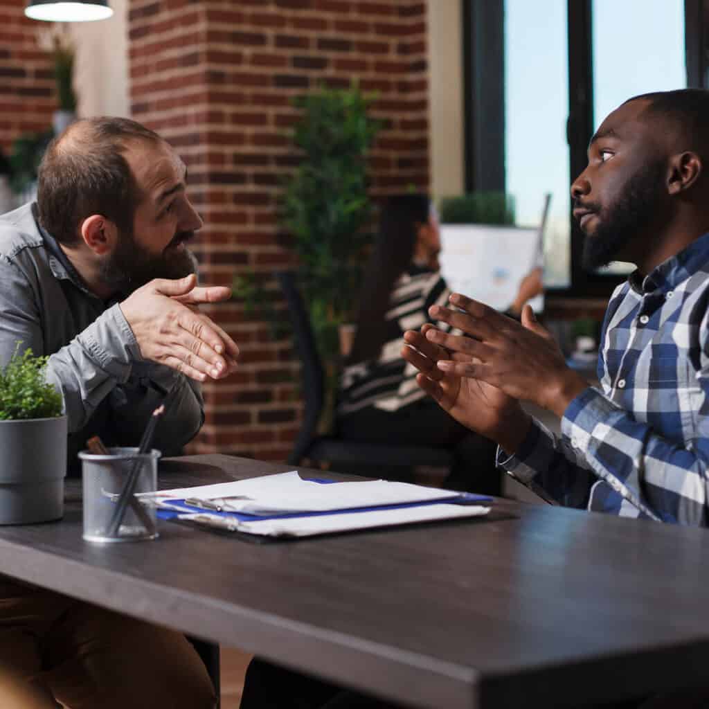 A hiring manager talks calmly to de-escalate an irritated job applicant.