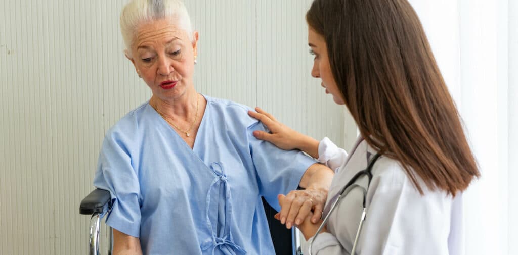 Upset senior patient talking with a doctor