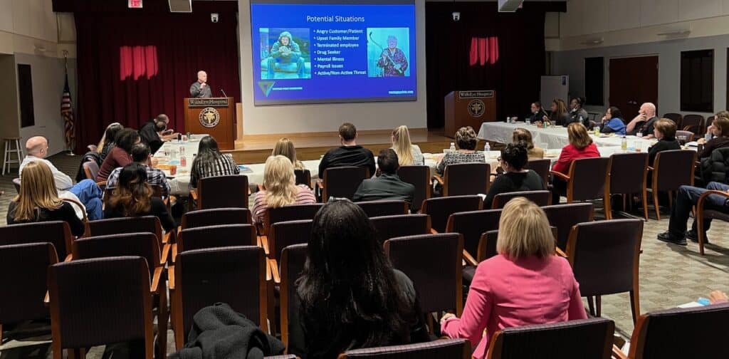 Dwight Frost presents de-escalation training to a room of attendees at Wills Eye Hospital in Philadephia, PA.