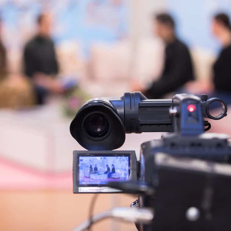 Camera at media conference in studio